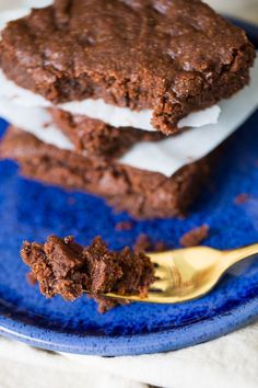 two chocolate cookies and ice cream on a blue plate