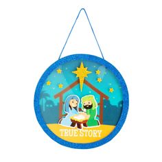 a blue christmas ornament with a nativity scene on the front and side