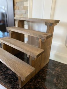 three wooden shelves sitting on top of a counter