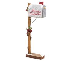 a wooden post with a mailbox on it and christmas decorations hanging from the top