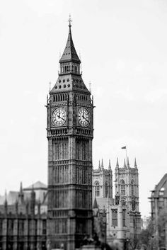 the big ben clock tower towering over the city of london, england in black and white