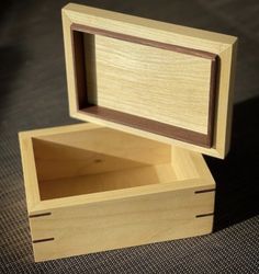 an empty wooden box sitting on top of a table