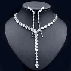 A beautiful piece of remarkable elegance, this exquisite necklace and earrings set will add a touch of sophistication to any wedding gown or formal ensemble. Adorned with intricately faceted cubic zirconia that capture the light from every angle with a perfectly translucent appeal, the pieces are platinum plated for a flawless finish which enhances the intricate detailing and conveys a modern take on old elegance. Necklace: The neck circumference is 16" (approx. 40.6cm) long and closes with a se Sapphire Jewelry Set, Butterfly Flying, Diamond Jewelry Set, Heart Shaped Necklace, Cubic Zirconia Necklace, Cubic Zirconia Jewelry, Fashion Jewelry Sets, Cz Jewelry, Geometric Necklace