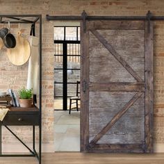 an open wooden door in front of a brick wall