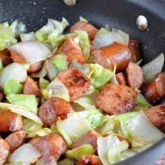 sausage and cabbage cooking in a skillet