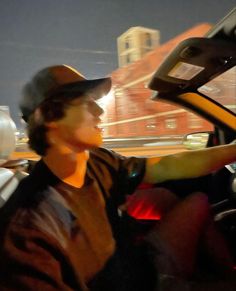 a man sitting in the driver's seat of a car