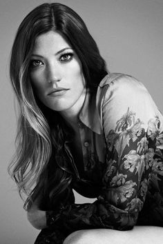 black and white photograph of a woman with long hair posing for a magazine cover photo