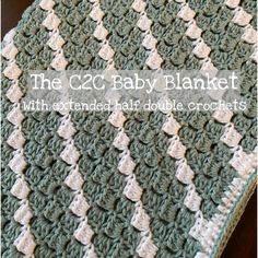 the crocheted baby blanket is green and white