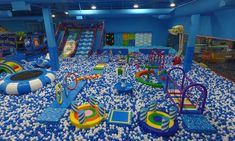 an indoor play area with water toys and slides