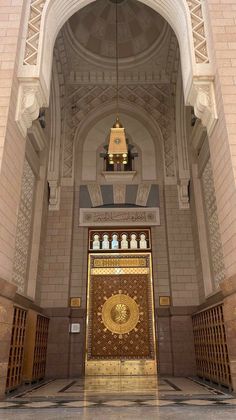 the inside of a building with a large golden door