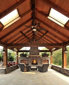 an outdoor living area with fireplace and seating