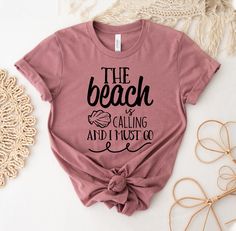 "The Beach Is Calling And I Must Go T-shirt, Beach Summer Shirt, Girls Weekend Tee,  Summer Vacation Top, Beach Matching Gift, Beach Tee, Family Vacation Tshirt, Summer Lover Shirt, Beach Summer Shirt, Summer Shirt, Beach Party Shirt, Summer Lover Shirt, The Beach Is Calling, And I Must Go, Family Vacation, Vacation Shirt, Beach Vibes Shirt, Beach Shirt, Girls Trip, Friends Vacation, Holiday Shirt This updated unisex essential fits like a well-loved favorite. Super soft cotton and excellent quality print makes one to fall in love with it over and over again. ------------- Fabrication ------------- 100% Combed ring spun cotton Made by specially treating the cotton fibers before spinning them into yarn. The result is stronger and smoother fabric. ------------- Unisex T-shirt Size Chart ----- Holiday Beach Tops With Letter Print, Letter Print Tops For Beach Holiday, Letter Print T-shirt For Beach Season Holiday, Beach Holiday Cotton T-shirt, Beach Season Holiday Cotton T-shirt, Beach Holiday Graphic Print T-shirt, Graphic Print T-shirt For Beach Holiday, Cotton T-shirt For Beach Holiday, Tequila Made Me Do It