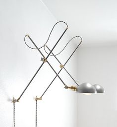 three lamps are hanging from the ceiling in a room with white walls and flooring