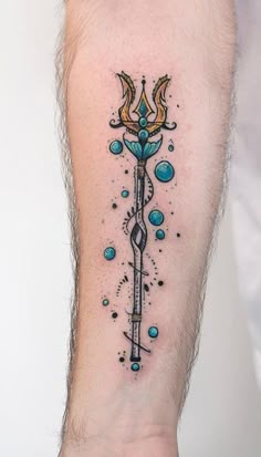 a person with a tattoo on their arm that has an arrow and stars in it