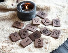 a candle and some wooden letters on a blanket