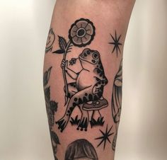 a tattoo on the leg of a person with a frog