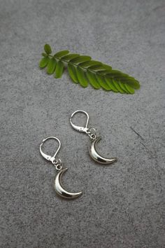 Silver plated lever back earrings with silver crescent moon charms dangling. Size of moon: 2cm x 2cm Free worldwide shipping Multiple orders receive a free gift <3 Packaging - Eco friendly and gift ready Each item is packaged keeping in mind an eco friendly policy. Jewelry is presented in a reusable organza bag in a recyclable/reusable gift box. Mystical Nickel-free Crescent Earrings, Mystical Moon Charm Dangle Earrings, Dainty Silver Earrings With Moon Charm, Mystical Sterling Silver Moon Charm Earrings, Moon Earrings Silver, Silver Moon Earrings, Boho Witch, Half Moon Earrings, Back Jewelry