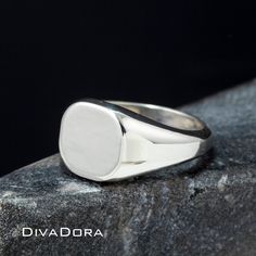 "We designed this signet ring with the look and feel of a true designer piece. The substantial weight of the solid 925 sterling silver and smooth curved edges make this a ring you will love to wear or gift with pride. We craft each piece to order and perform the laser engraving in our Los Angeles workshop. Since we control every step of the creation our team can craft a custom ring for you in only a few days! We can engrave the ring with a monogram, a single initial or work with you to create a Timeless Silver Jewelry With Engraving Option, Classic 14k White Gold Polished Signet Ring, Sterling Silver Symbolic Signet Ring With Polished Finish, Symbolic Sterling Silver Signet Ring With Polished Finish, Sterling Silver Signet Ring Fine Jewelry, White Sterling Silver Oval Signet Ring, Classic White Gold Jewelry Stamped 925, Timeless Sterling Silver Signet Ring With Polished Finish, Timeless White Gold Sterling Silver Signet Ring