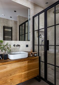 a bathroom with a sink, mirror and shower