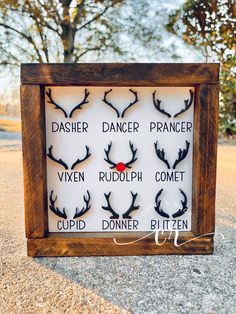 a wooden frame with deer antlers on it and the words dasher, dancer, vixen rudolph, comet, cupid, donner, bitter