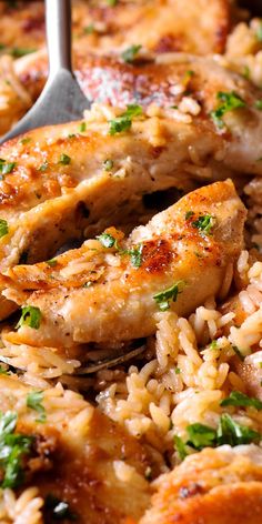 chicken and rice in a skillet with a serving utensil on the side