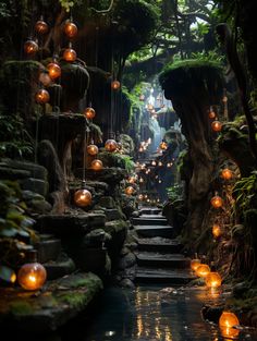 candles are lit on the steps leading up to a waterfall in a forest filled with trees