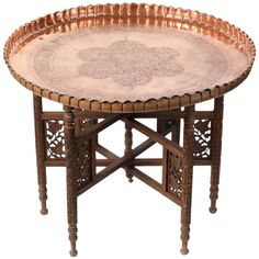 an ornately decorated wooden table with metal trays