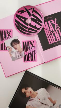 a pink album with black and white images on it, next to a cd case