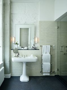 a bathroom with a pedestal sink, toilet and bathtub in the middle of it