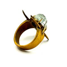 an antique gold ring with glass stones in it's center and two claws on the side