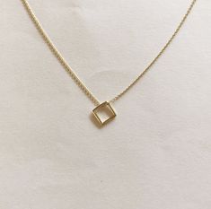 FREE SHIPPING, 14k yellow solid gold square necklace. It can be produce 14k rose gold and white gold. DETAILS Chain is shown length approx. 40 cm (16 inch) and thickness is 1mm (0.04 inch). Pendant height is 0.8 cm (0.3 inch). Chain can be lengthened for choosing option. The chain has a spring ring clasp. You may order a shorter or longer chain by leaving a note during checkout. MATERIALS All our jewelry are made of 14 karats solid gold. We like to use yellow gold, white gold and rose gold to pl Minimalist Diamond-shaped Necklace For Gift, Modern 14k Gold Square Pendant Jewelry, Square Box Chain Necklace For Gift, Minimalist 14k Gold Necklace With Square Pendant, Minimalist 14k Gold Square Pendant Necklace, Minimalist Square White Gold Jewelry, Square Diamond Cut Jewelry For Gifts, 14k Gold Square Pendant Necklace With Box Chain, Modern 14k Gold Square Pendant Necklace