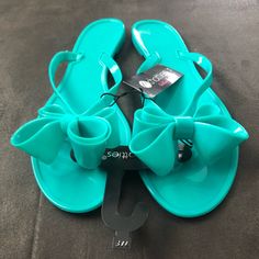 Brand New Teal Bow Sandals Size 7/8 Trendy Blue Sandals For Beach Season, Blue Synthetic Jelly Sandals For Summer, Turquoise Flip Flops For Beach In Spring, Blue Flat Jelly Sandals For Summer, Turquoise Open Toe Flip Flops For Spring, Trendy Blue Flip Flops For Summer, Blue Open Toe Jelly Sandals For Vacation, Blue Open Toe Jelly Sandals For Summer, Blue Jelly Sandals For Summer Beach