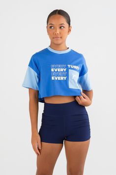 Active meets street style in your new essential Tee—the Elle Cropped Overise T-Shirt in Blueberry Blue. It’s got a cropped oversized fit that’s a wardrobe must-have, paired with athletic color blocking and an Every Turn screen print graphic. Made to be worn all day long. Boxy Fit Athleisure Top For Streetwear, Trendy Cotton Cropped T-shirt For Sports, Sporty Graphic Print Crop Top In Relaxed Fit, Trendy Relaxed Fit Sports Crop Top, Sporty Crop Top With Graphic Print In Relaxed Fit, Trendy Relaxed Fit Crop Top For Sports, Sporty Crop Top With Graphic Print, Sporty Crop Top With Graphic Print And Relaxed Fit, Oversized Sporty Crew Neck Crop Top