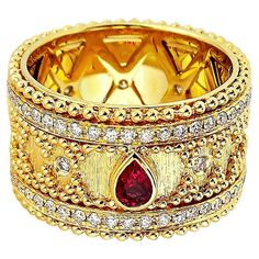 Produced by award winning Italian designer Stefano Vitolo. Stefano creates custom artisanal one of a kind jewelry with excellent gemstones in a truly old world Italian craftmanship. Sophisticated hand engraved design that blends traditional granulation technique with a modern twist. This handcrafted ring has ruby 0.20 carat and diamonds 0.78 carat weight of F/G color, VS clarity diamonds. Luxury Multi-stone Ruby Ring, Luxury Diamond Ring With Decorative Band, Luxury Ruby Ring With Gemstone Accents For Anniversary, Luxury Ruby Ring With Diamond Accents, Luxury Gold Ruby Ring With Intricate Design, Elegant Ceremonial Rings With Gemstone, Elegant Ceremonial Gemstone Rings, Elegant Ceremonial Jewelry With Decorative Band, Luxury Gold Ruby Ring With Accent Stones