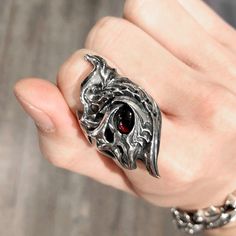 made by GLAM SCALE dragon eye garnet stone gothic silver ring made in JAPAN if you want other ring gauge please contact us. Gothic Metal Rings, Gothic Skull Ring With Polished Finish Gift, Gothic Style Silver Ring With Gemstone, Collectible Gothic Rings With Polished Finish, Gothic Metal Rings For Collectors, Gothic Skull Ring With Polished Finish, Gothic Hand Cast Metal Rings, Gothic Silver Ring With Gemstone, Dragon Eye Jewelry