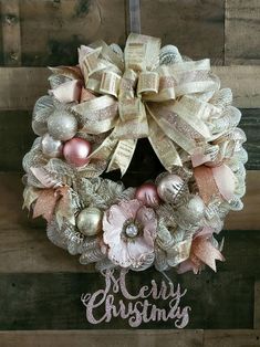 a christmas wreath hanging on the side of a wooden wall