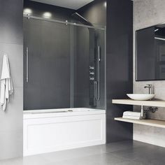 a bathroom with a sink, mirror and bathtub next to the shower stall is shown