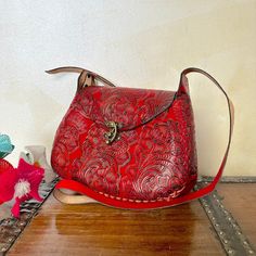 "MADE IN MEXICO By: Mexican Artisans For: Women Color: red Dimensions: 9.5 x 8 x 2.5 Details: - 100% Authentic Leather - Style: Crossbody | Shoulder Bag - Embossed Design - Hook lock closure - Adjustable & Non-Removable Strap: 22\" Drop Contact us for more details PLEASE READ BEFORE PURCHASE: The picture is an ACCURATE REPRESENTATION. Colors in the pictures may vary a little by effects of light. Each product is handmade from Mexico causing differentiation and minor imperfections in each piece making them that much more unique. We strive to have consistency within our business but please be aware not all pieces are 100% alike. Please Read our Return Policy to learn more about returning or exchanging purchased items" Red Satchel Shoulder Bag With Mobile Phone Pocket, Red Leather Saddle Bag In Satchel Shape, Red Crossbody Mobile Phone Bag, Red Leather Satchel Saddle Bag, Red Mobile Phone Crossbody Bag, Red Leather Rectangular Saddle Bag, Red Flap Bag With Mobile Phone Bag For Travel, Red Flap Bag With Mobile Phone Pocket For Travel, Red Flap Bag With Mobile Phone Holder For Travel