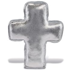 a silver cross shaped pillow on a white background