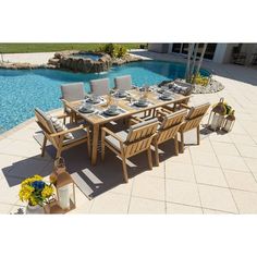 an outdoor dining table and chairs next to a swimming pool