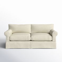 a white couch sitting on top of a white floor