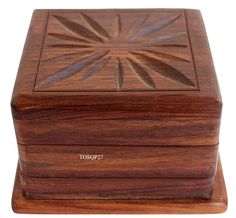 a wooden box with a flower design on it