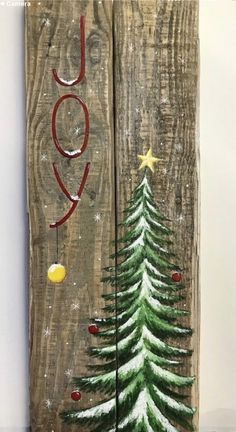 two wooden boards with christmas trees painted on them and the words joy written in red