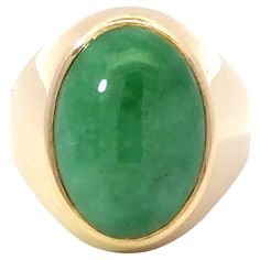 Item Specifications: Metal: 14k Yellow Gold Style: Statement Ring Ring Size: 8.75 (resizing available for a fee) Total Weight: 13.2 Grams Gemstone Specifications: Center Gemstone: Jadeite Jade Shape: Oval Color: Green Cut: Cabochon ​ ​Jade Measurements: ~18.5 mm x 13.3 mm 5.8 mm Jade Carat Weight: ~13 carats Condition: Vintage, Excellent ​ ​Stamped: "14k" Oval Gemstone Dome Ring In Yellow Gold, Oval Polished Emerald Ring In 14k Gold, Oval Emerald Ring With Polished Finish In 14k Gold, Oval Emerald Ring In 14k Gold With Polished Finish, Green Oval Dome Ring For Formal Occasions, 14k Yellow Gold Emerald Ring Oval Cabochon, Modern Oval Cabochon Signet Ring, Oval Cabochon Signet Ring In Fine Jewelry Style, Oval 14k Gold Emerald Ring