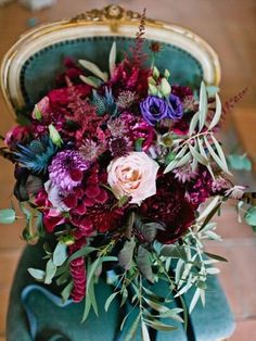 a bouquet of flowers sitting on top of a green chair