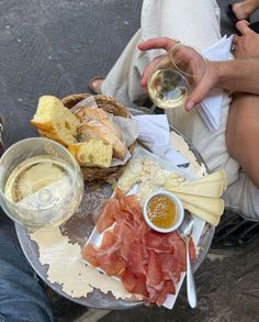 a person sitting at a table with food and wine