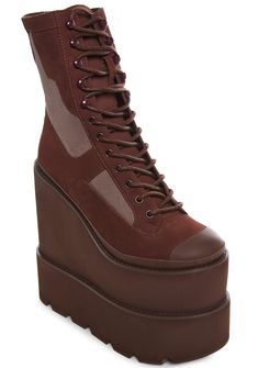 have adjustable lace-up closures, embroidered logo details on the back, and pull tabs on the back. These wedge boots feature a double stacked platform design and a paneled faux suede and leather construction. Brown Lace-up Platform Combat Boots, Trendy Lace-up Platform Wedge Boots, High-top Suede Boots With Lace-up Fastening, High-top Suede Boots With Front Lace-up, Suede High-top Boots With Front Lace-up, Lace-up Platform Wedge Boots For Streetwear, Fall Wedge Lace-up Boots With Lug Sole, Fall Lace-up Wedge Boots With Lug Sole, Brown Suede Lace-up Combat Boots