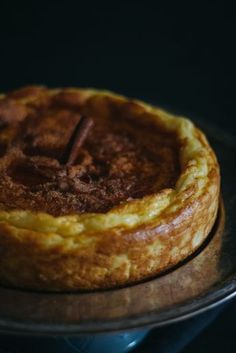 a baked pastry sitting on top of a metal pan with a wooden stick sticking out of it