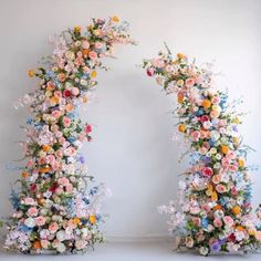 two floral archways are decorated with flowers