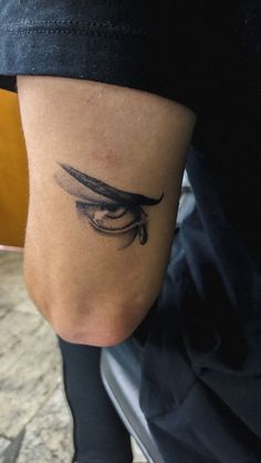 a woman's leg with a tattoo on it that has an eye in the middle